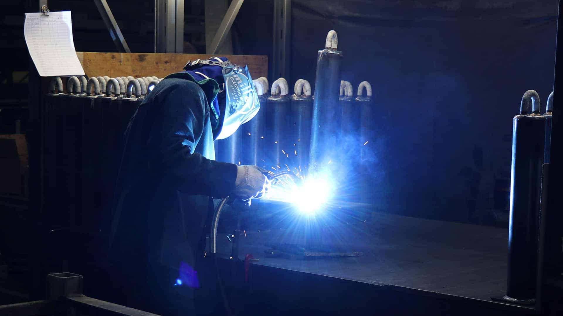 men welding in dark