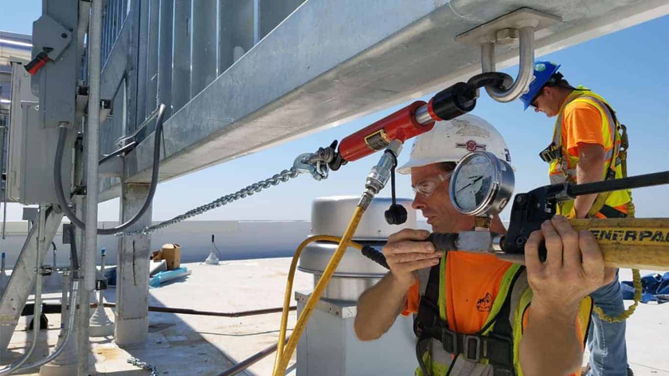 Wall anchors being pull tested by Pro-Bel inspector