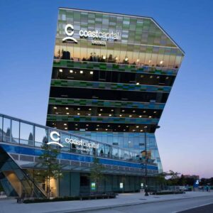 A mid-rise glass building with "Coast Capital" written on its side, equipped with window washing davits and permanent roof anchors