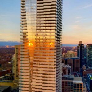 Glass skyscraper with cement balconies jutting out in downtown Toronto, equipped with window washing davits and permanent roof anchors